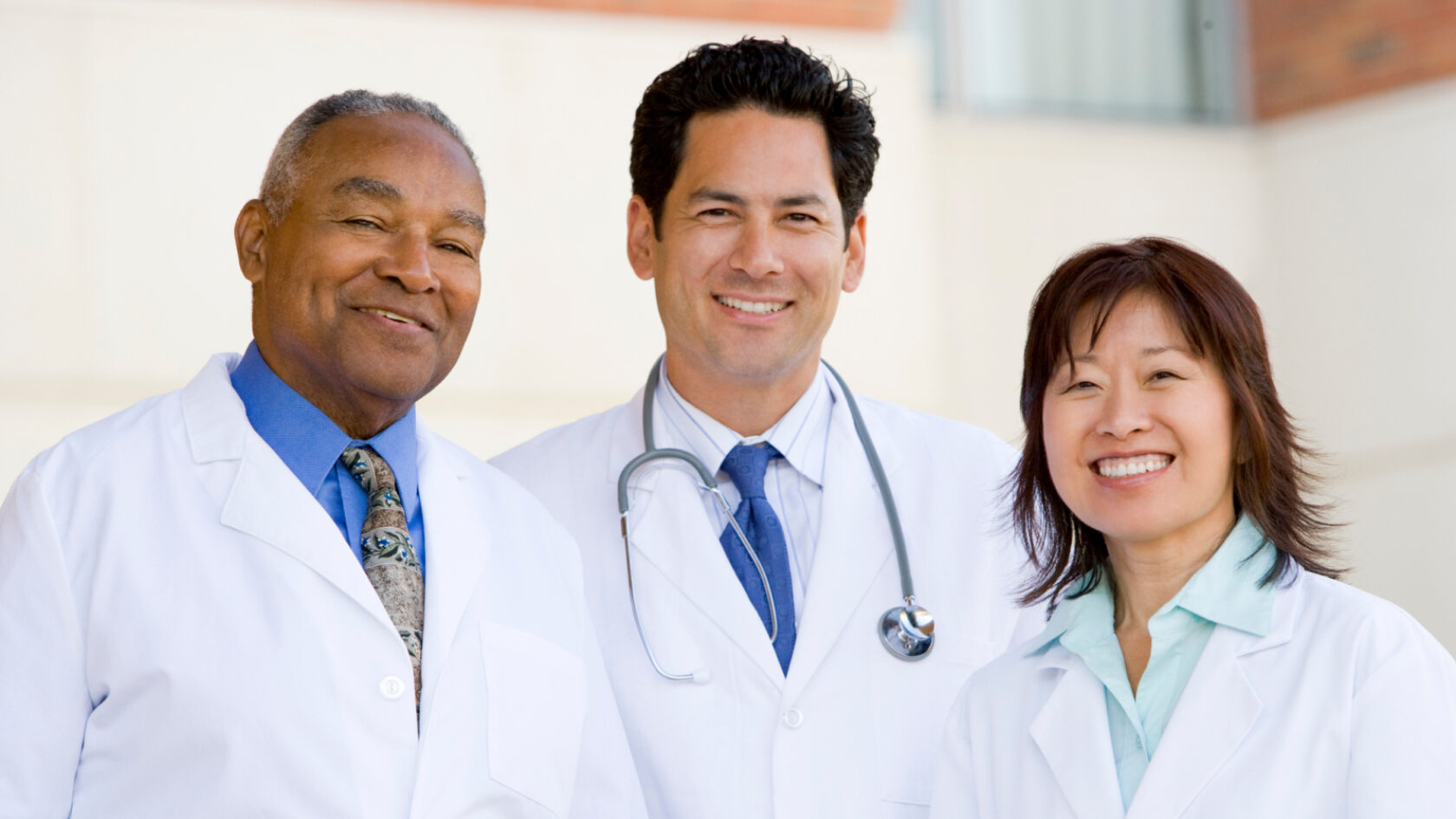 Three doctors pose for a picture.