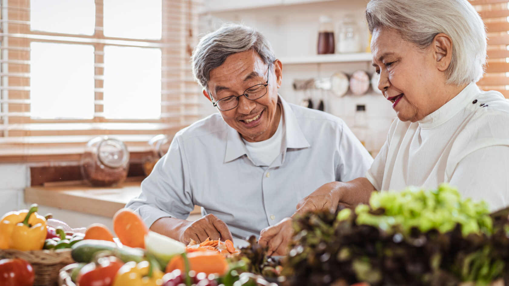 A couple prepares a meal in their kitchen.