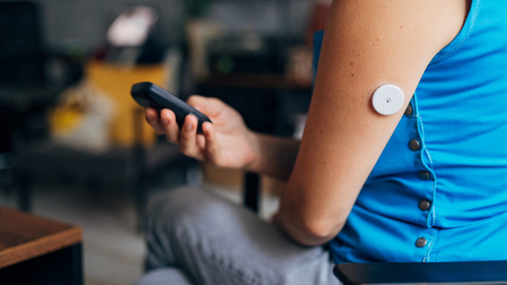 A person checks their blood sugar levels using a digital device.