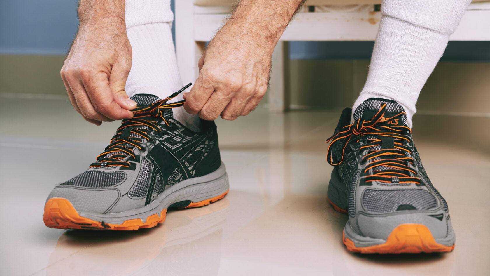 A person ties their shoelaces.