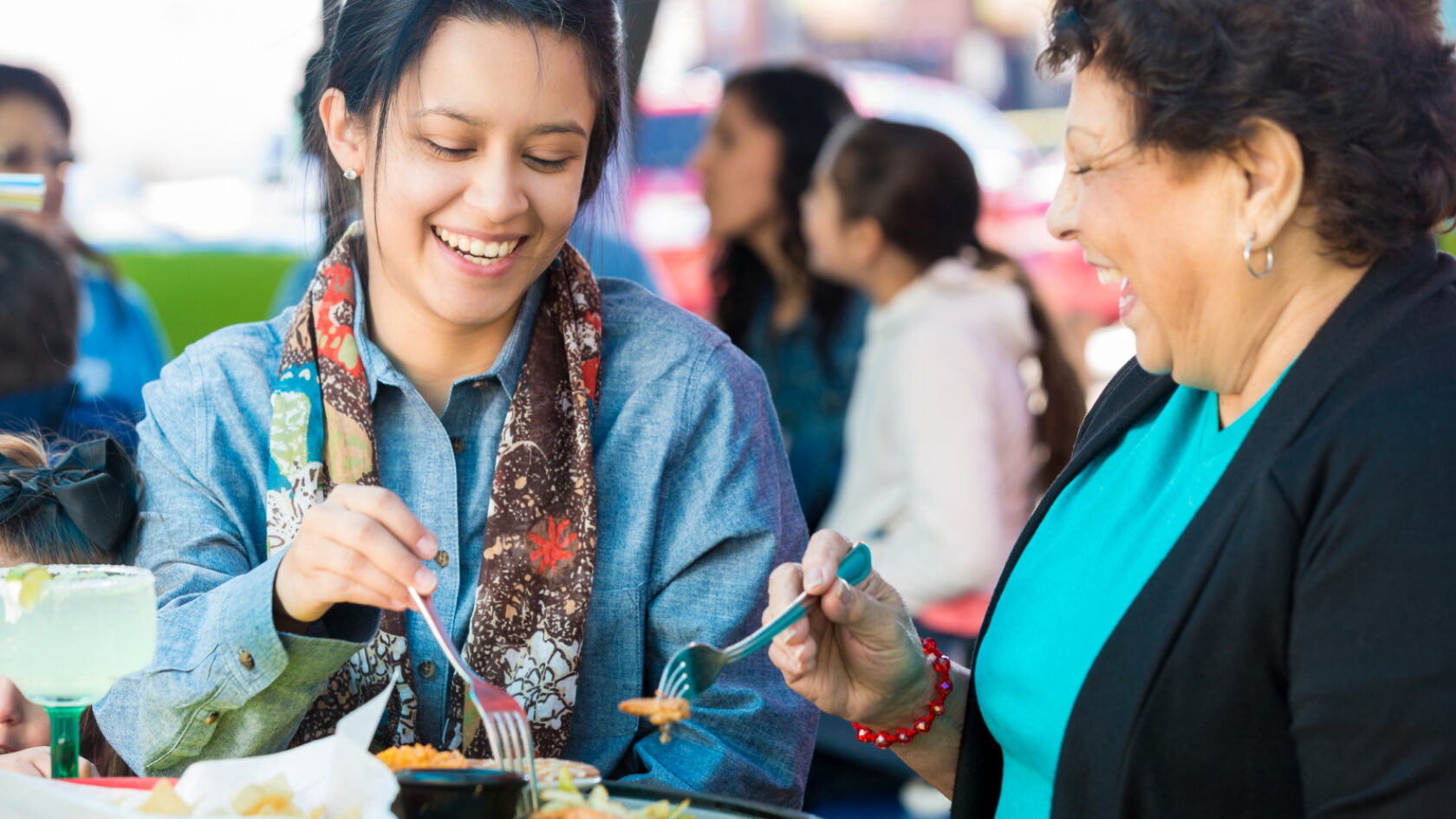 Dos mujeres almuerzan afuera de un restaurante.